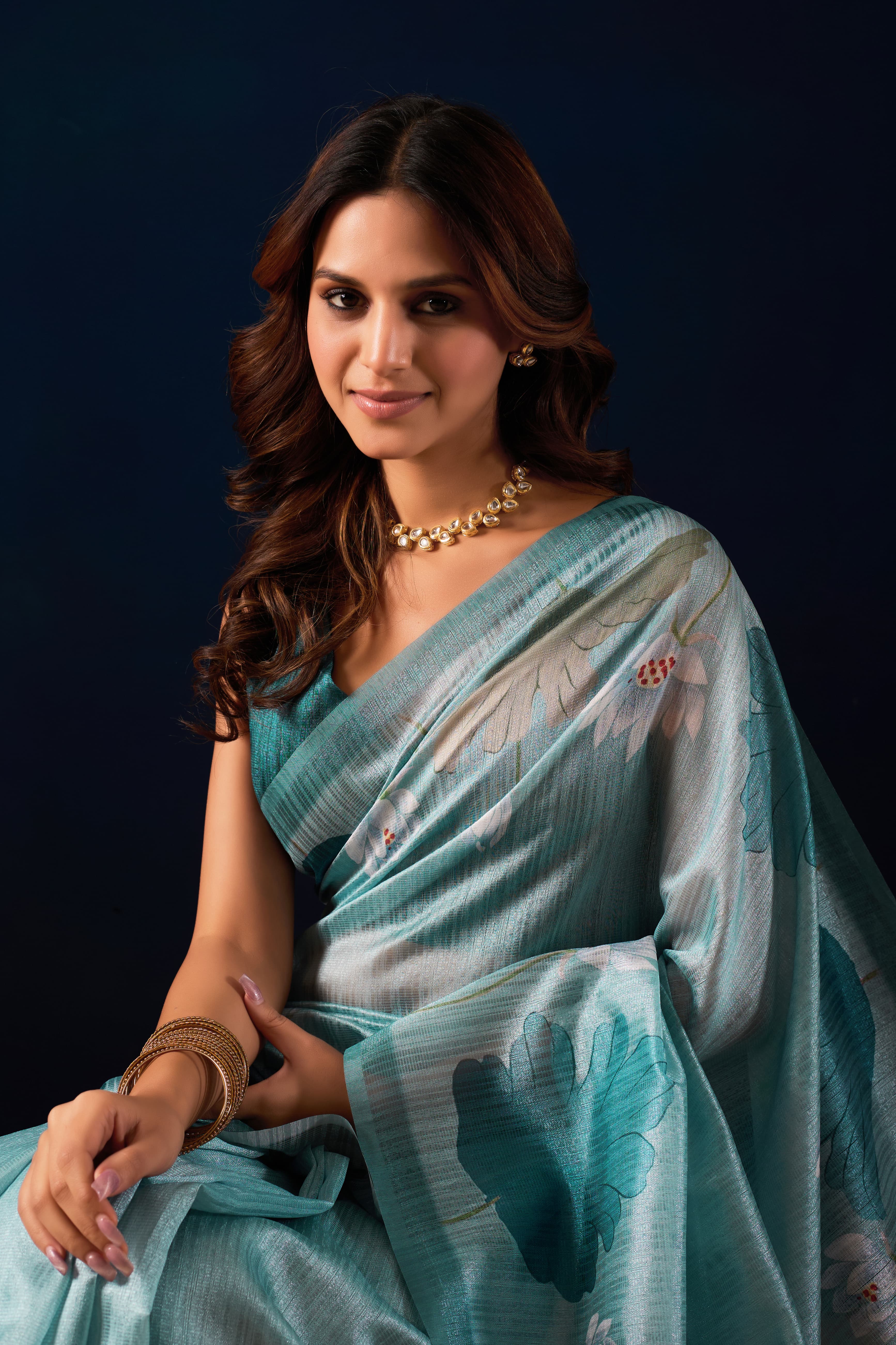 A Shimmering Seafoam Saree with Elegant Floral Artistry.