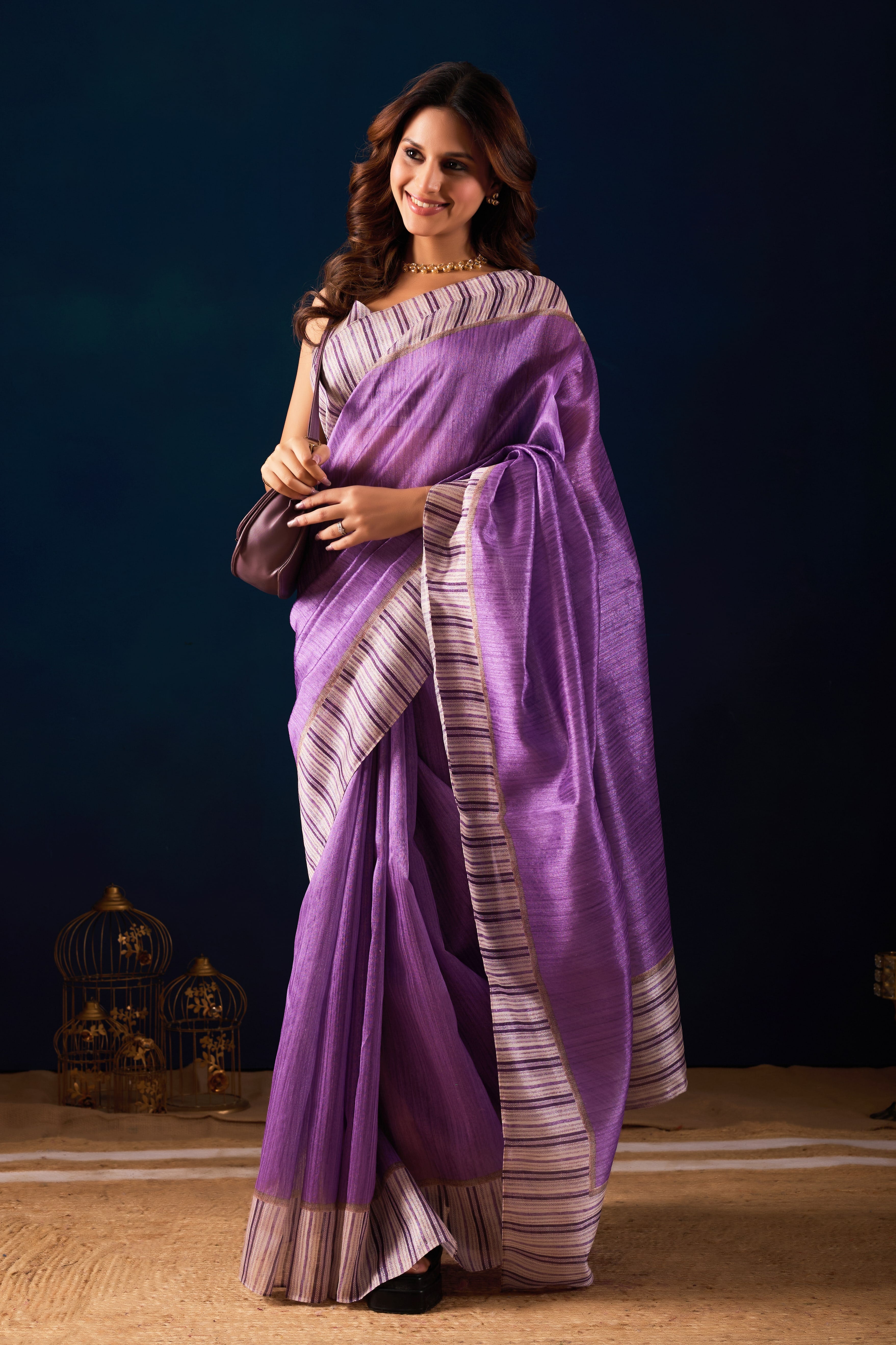 A Shimmering Purple Saree with Contemporary Striped Borders.