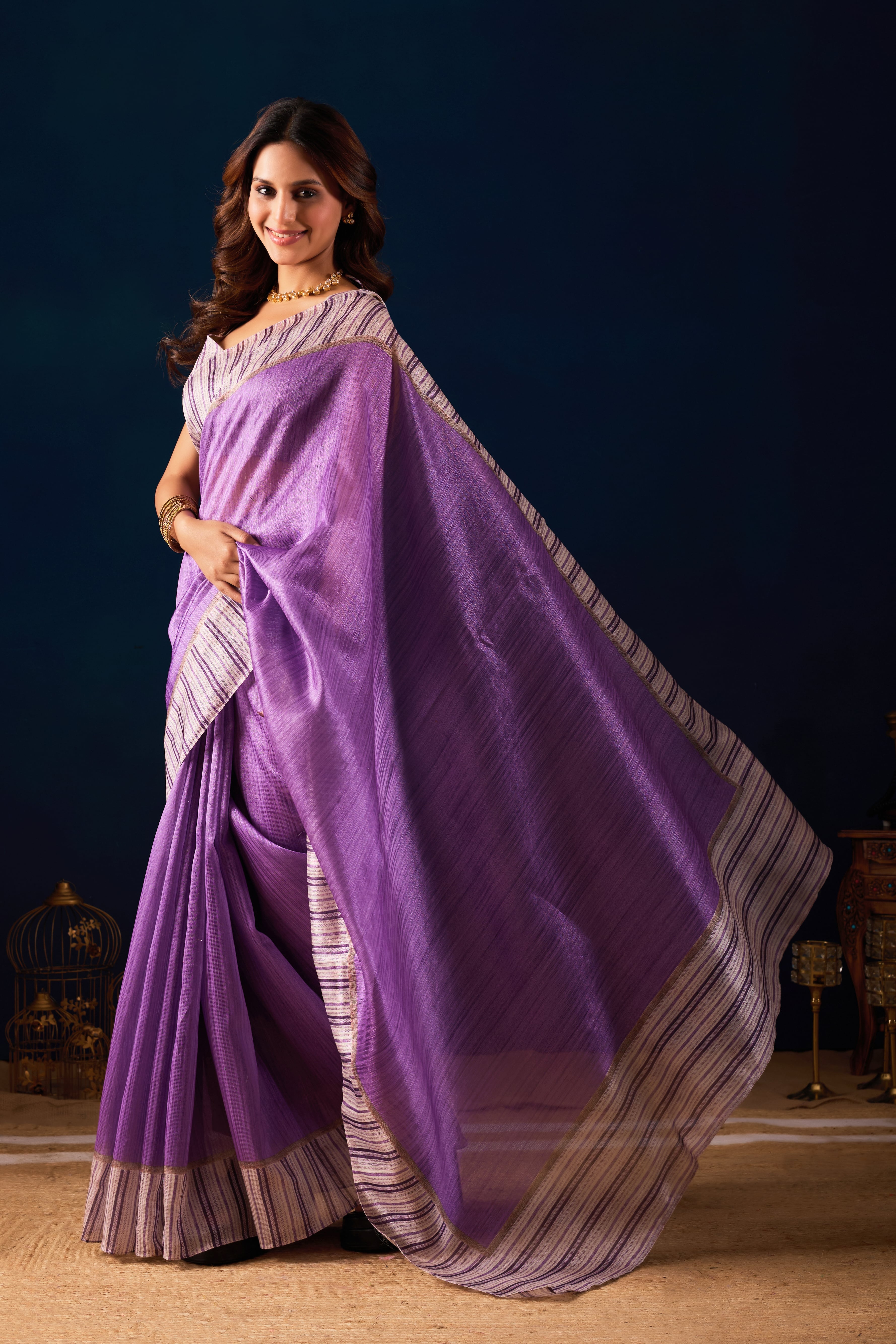 A Shimmering Purple Saree with Contemporary Striped Borders.