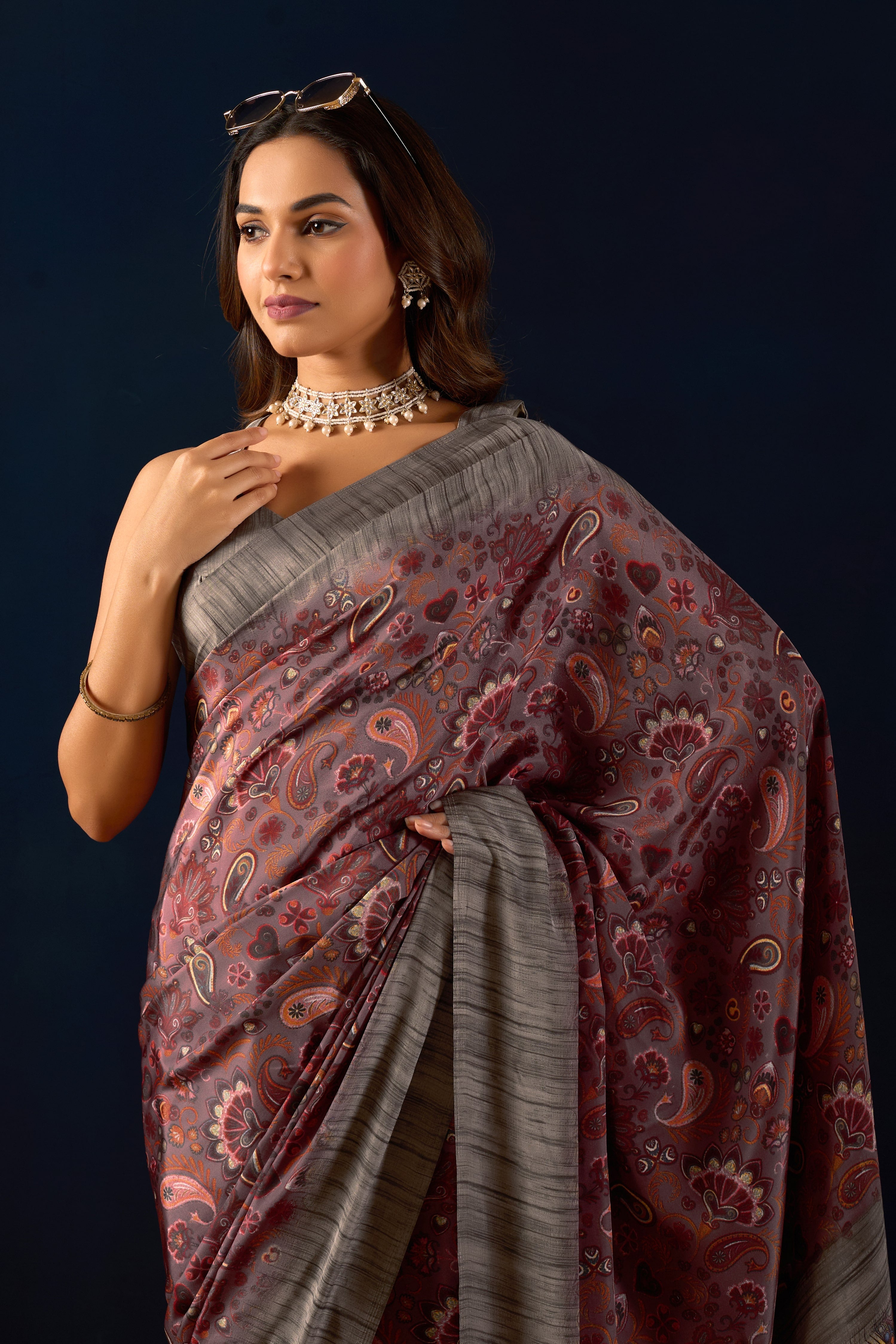 Gemini said Sophisticated Mauve Poly Crepe Saree with Regal Paisley Prints and Ornate Heritage Borders .