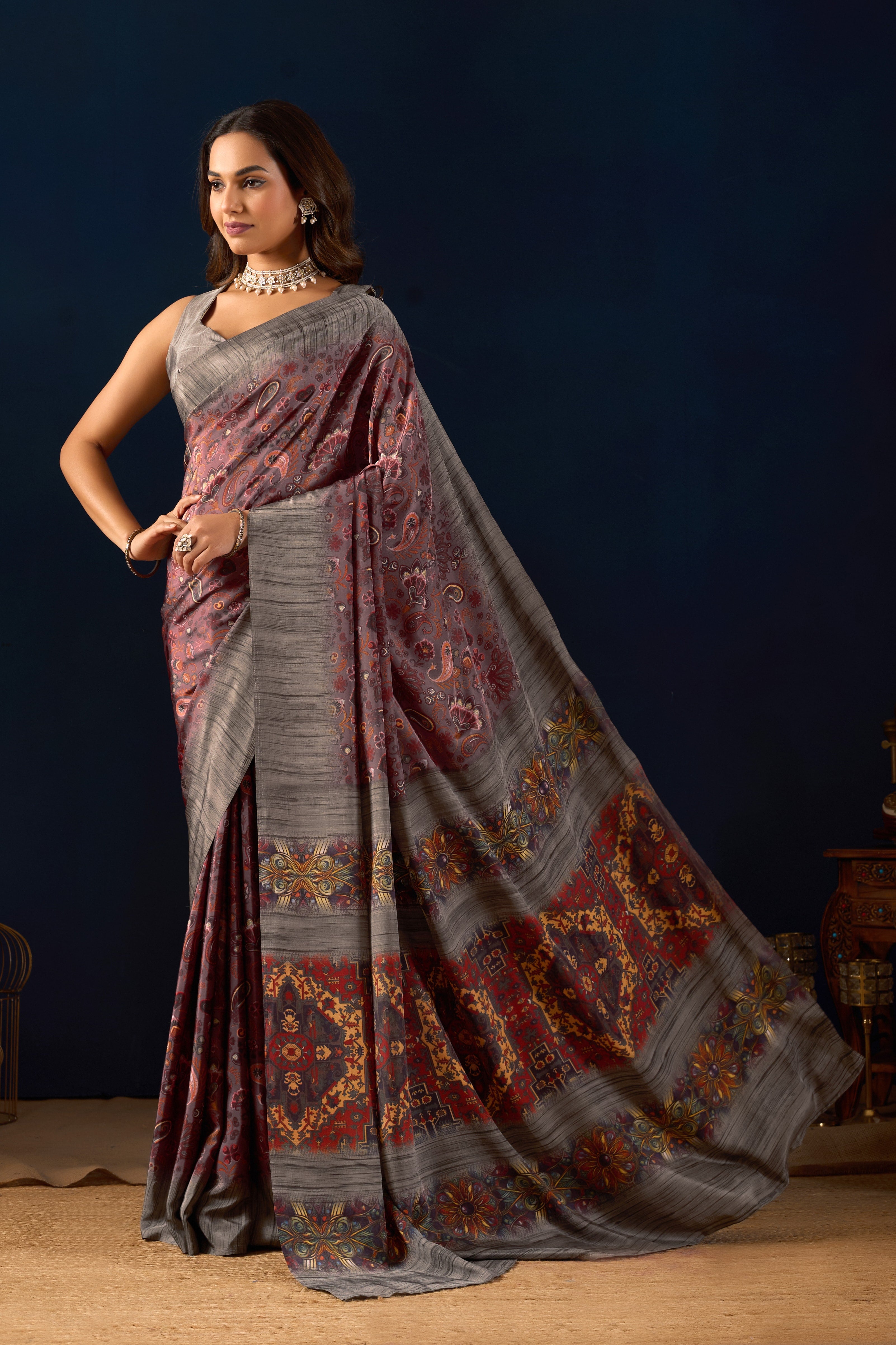 Gemini said Sophisticated Mauve Poly Crepe Saree with Regal Paisley Prints and Ornate Heritage Borders .