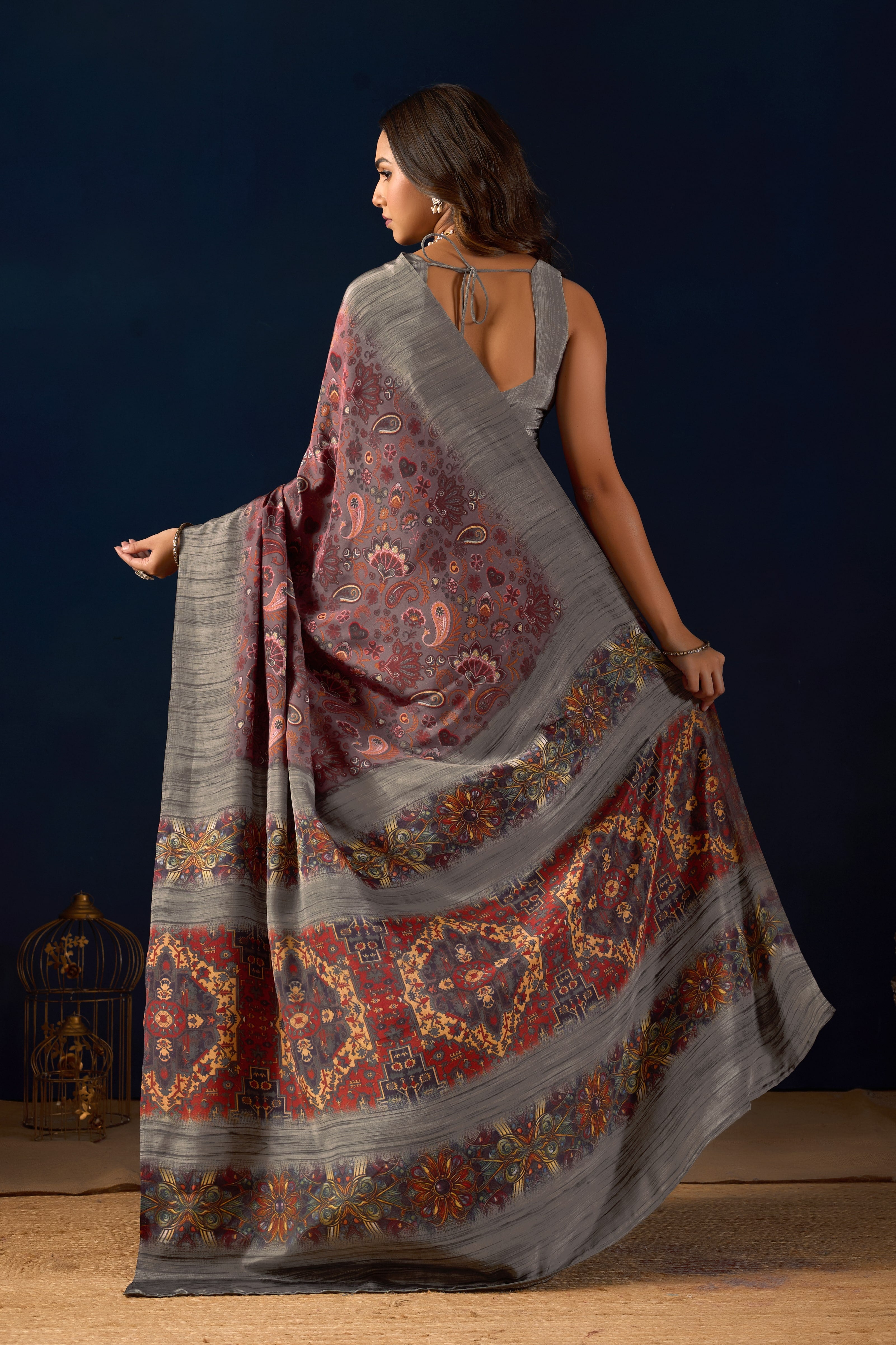 Gemini said Sophisticated Mauve Poly Crepe Saree with Regal Paisley Prints and Ornate Heritage Borders .