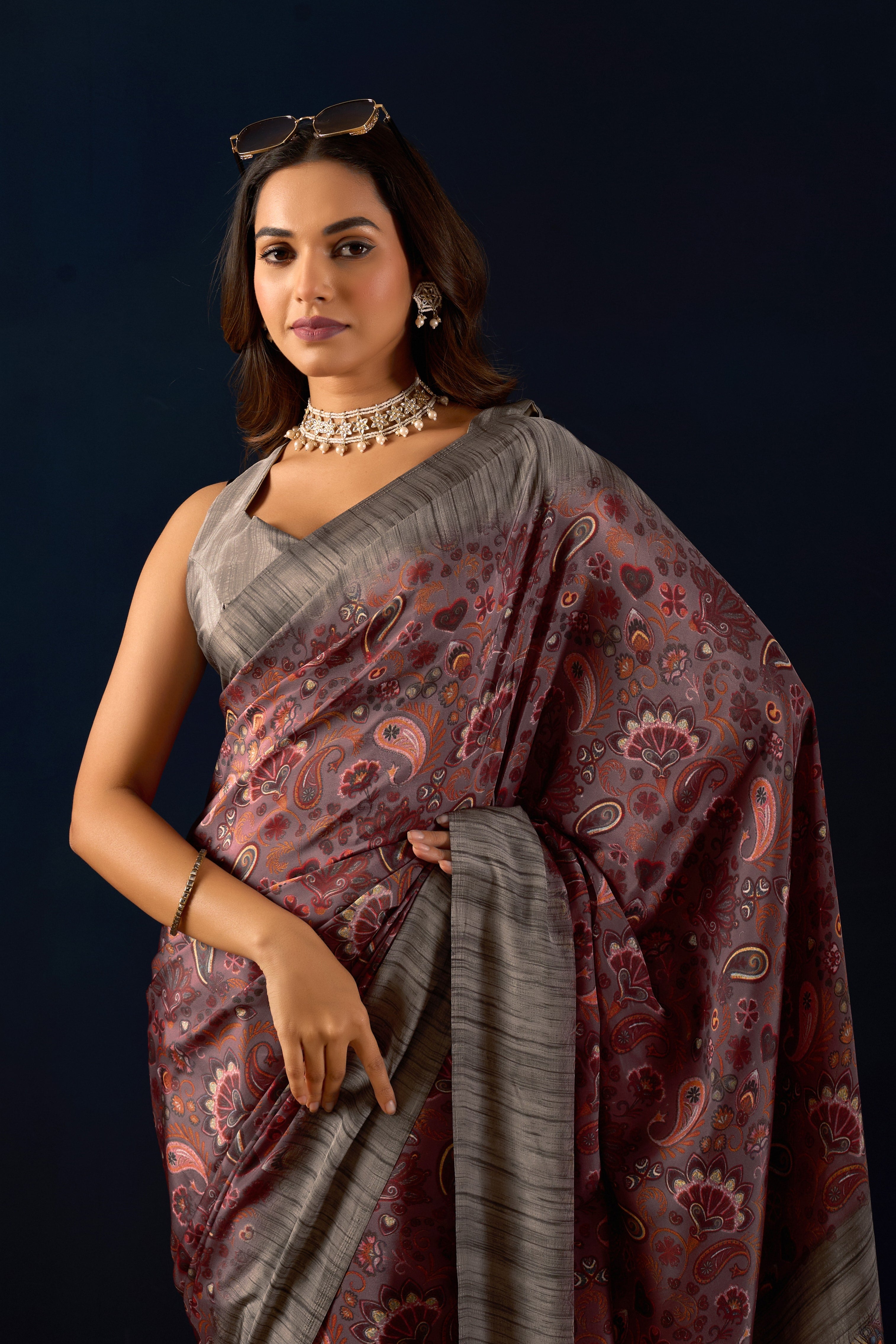 Gemini said Sophisticated Mauve Poly Crepe Saree with Regal Paisley Prints and Ornate Heritage Borders .