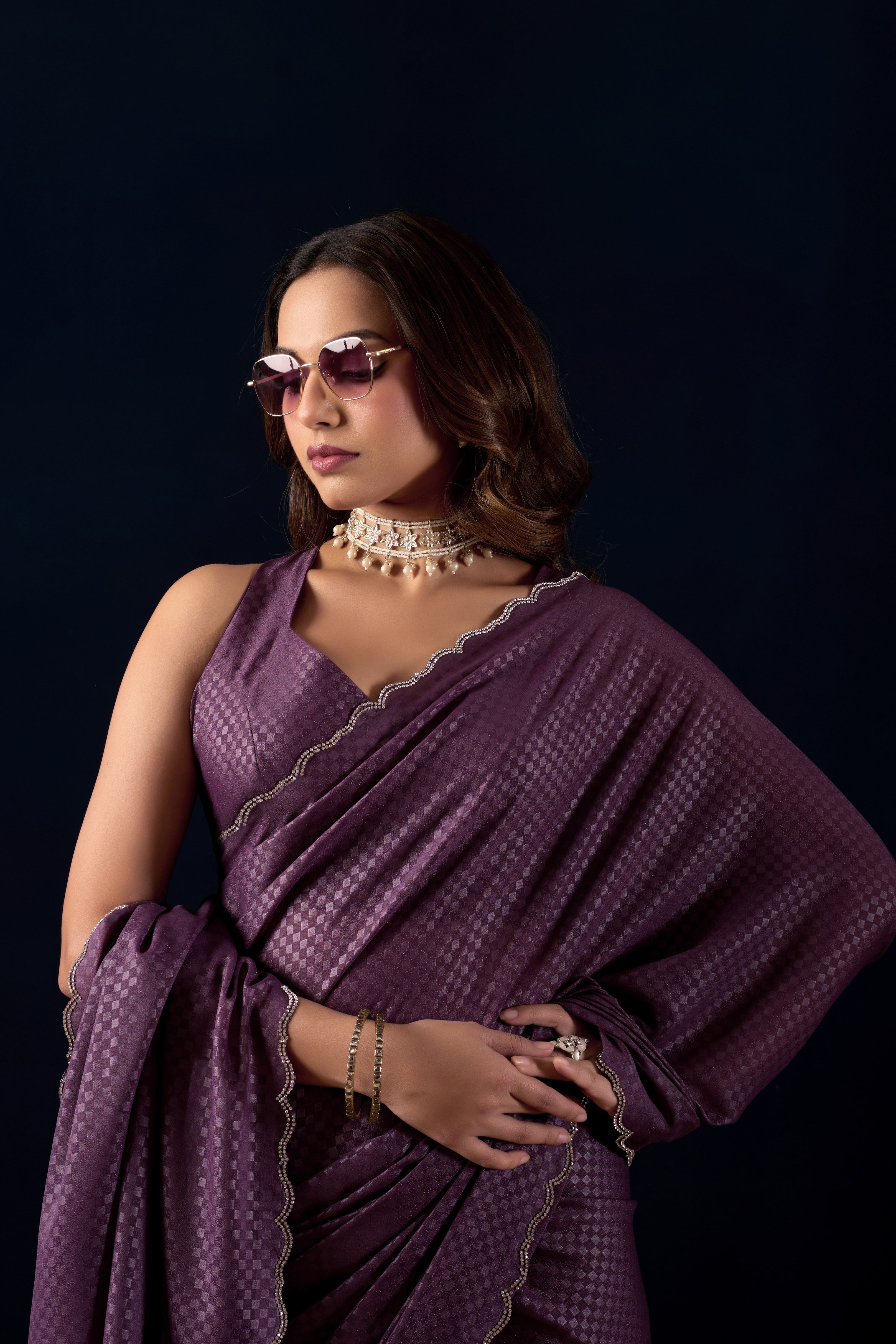 Shimmering metallic checkered Poly Georgette saree with an elegant scalloped border.