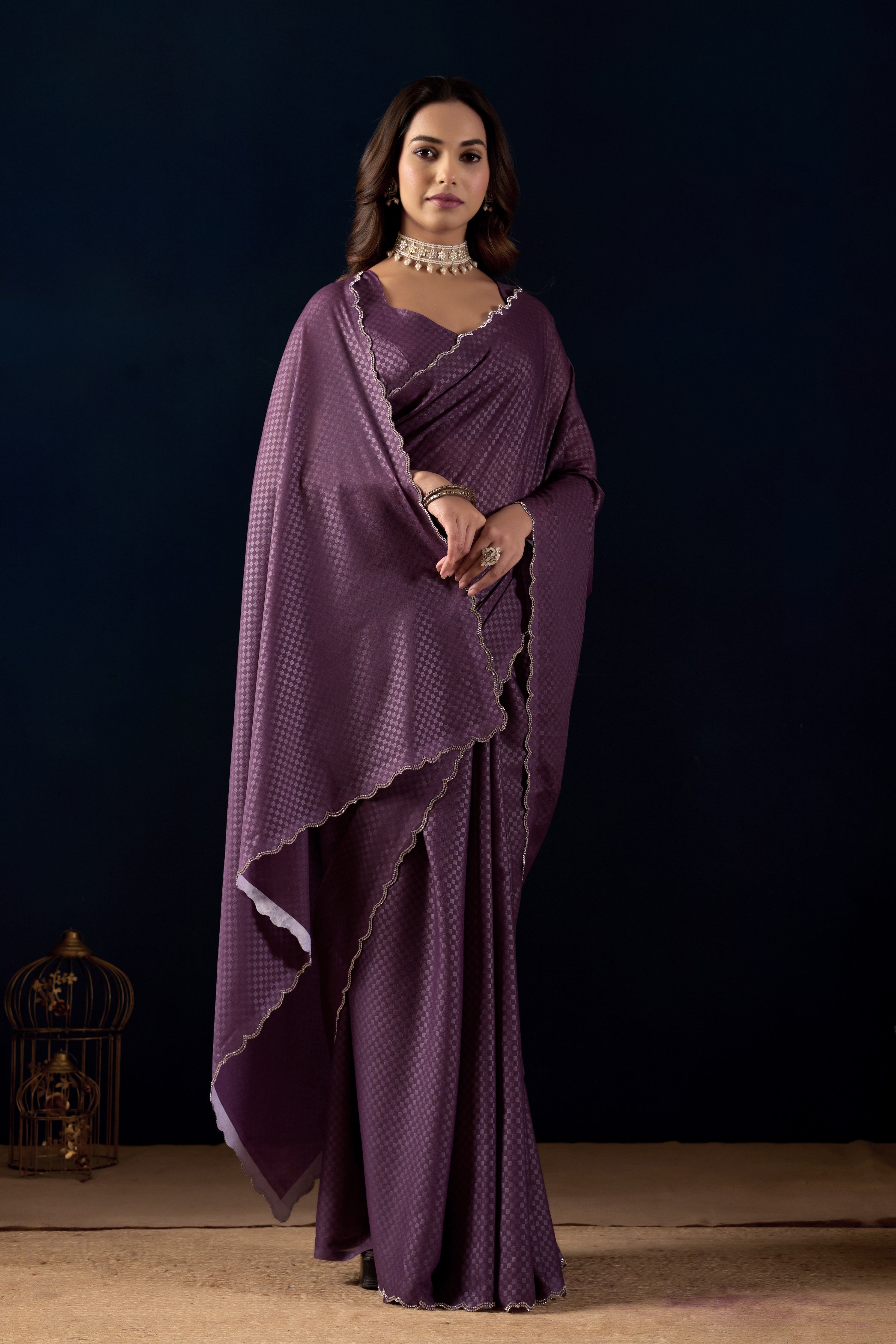 Shimmering metallic checkered Poly Georgette saree with an elegant scalloped border.