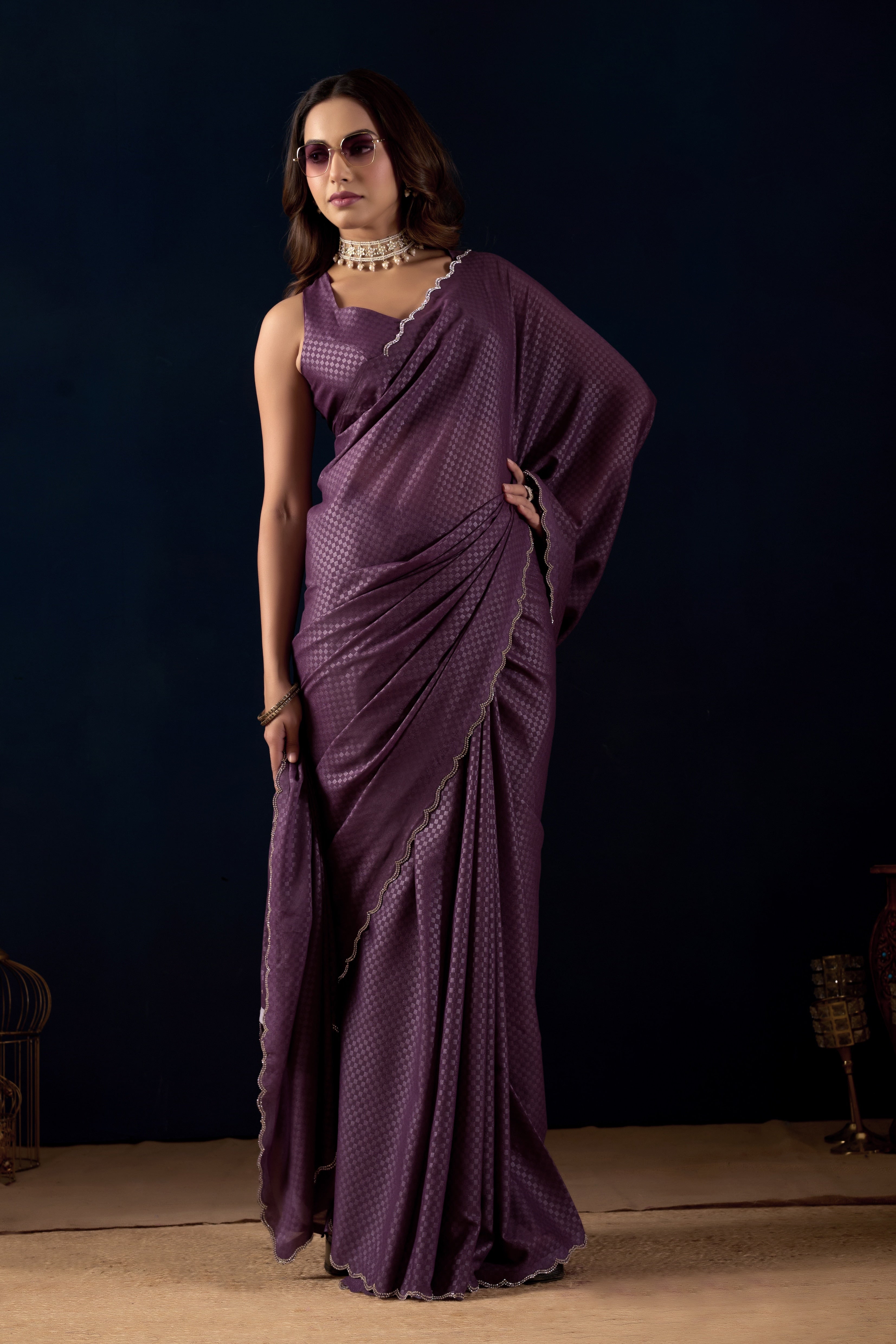 Shimmering metallic checkered Poly Georgette saree with an elegant scalloped border.