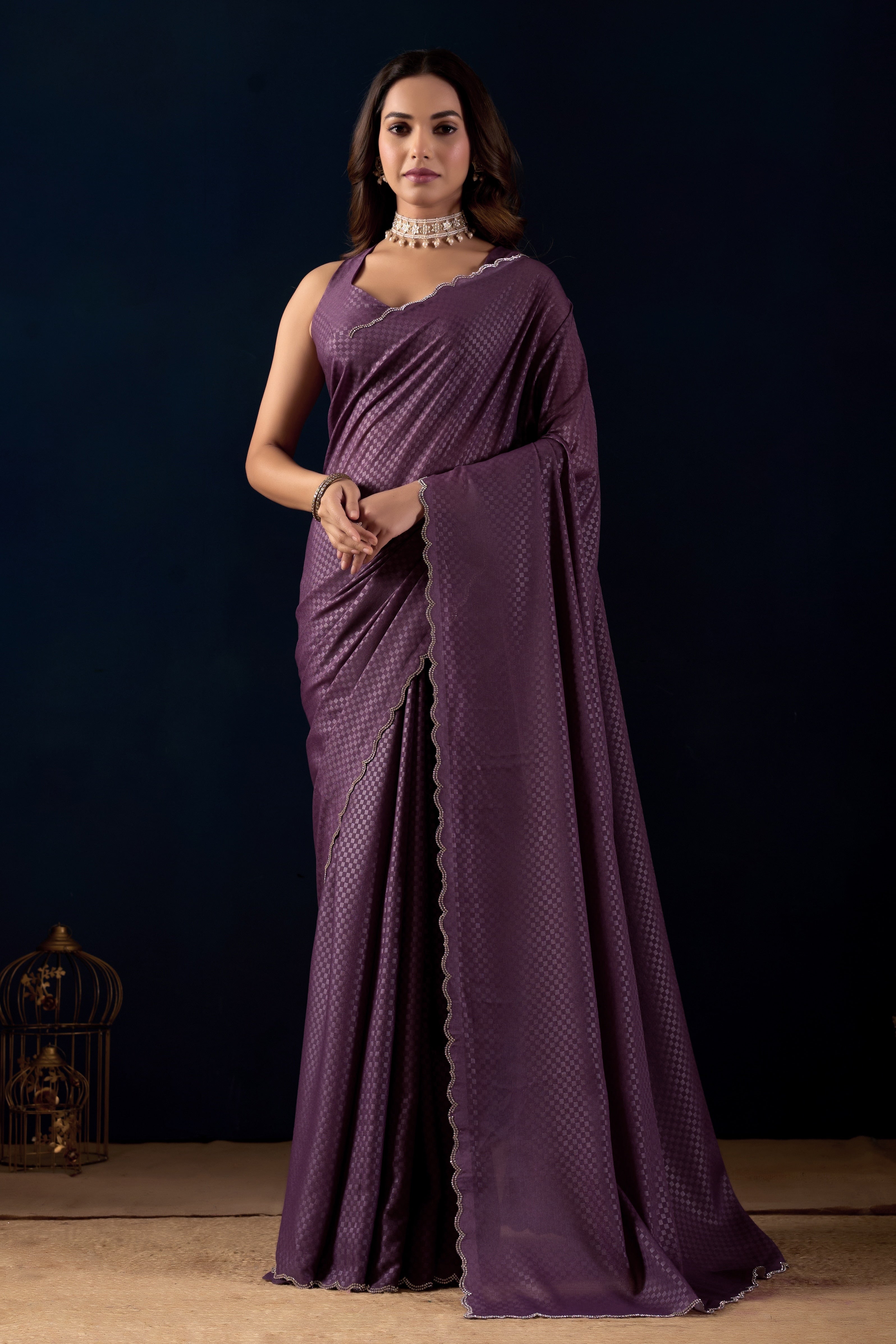 Shimmering metallic checkered Poly Georgette saree with an elegant scalloped border.