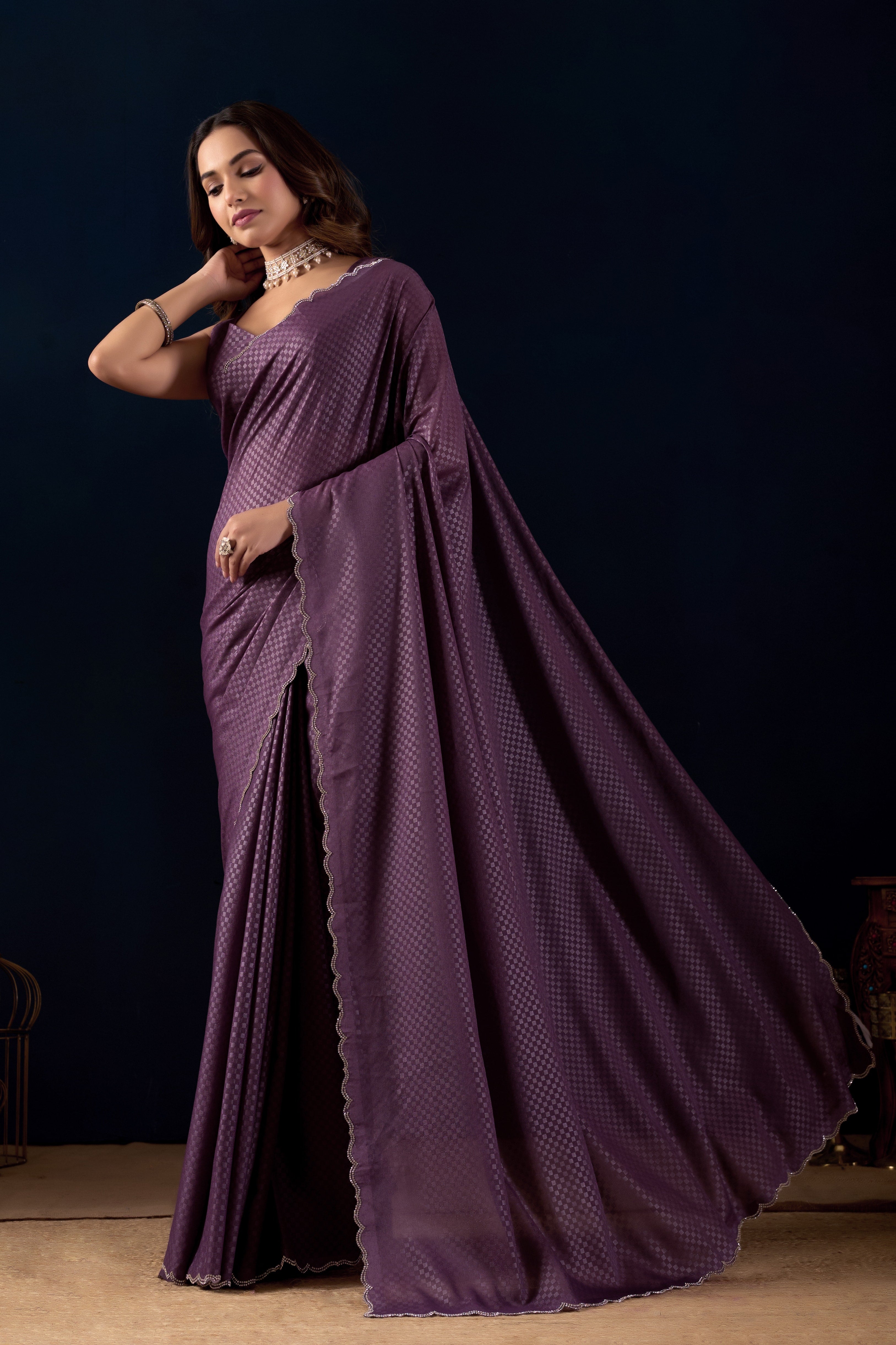 Shimmering metallic checkered Poly Georgette saree with an elegant scalloped border.