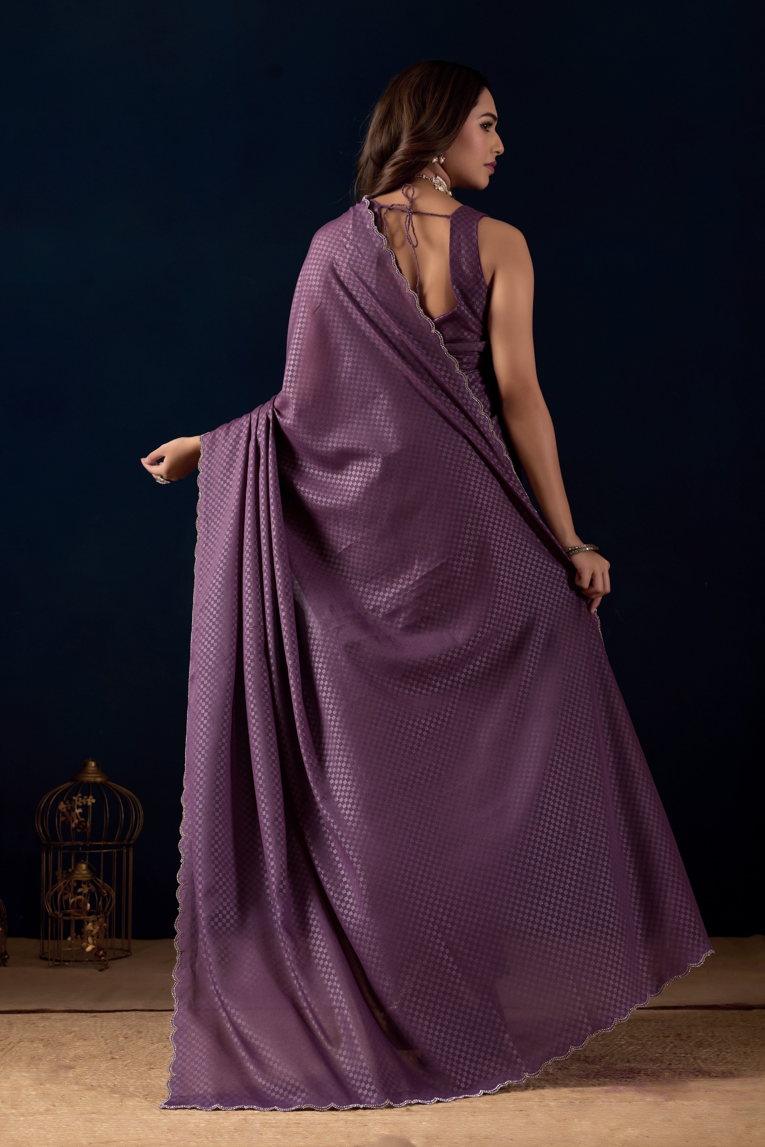 Shimmering metallic checkered Poly Georgette saree with an elegant scalloped border.
