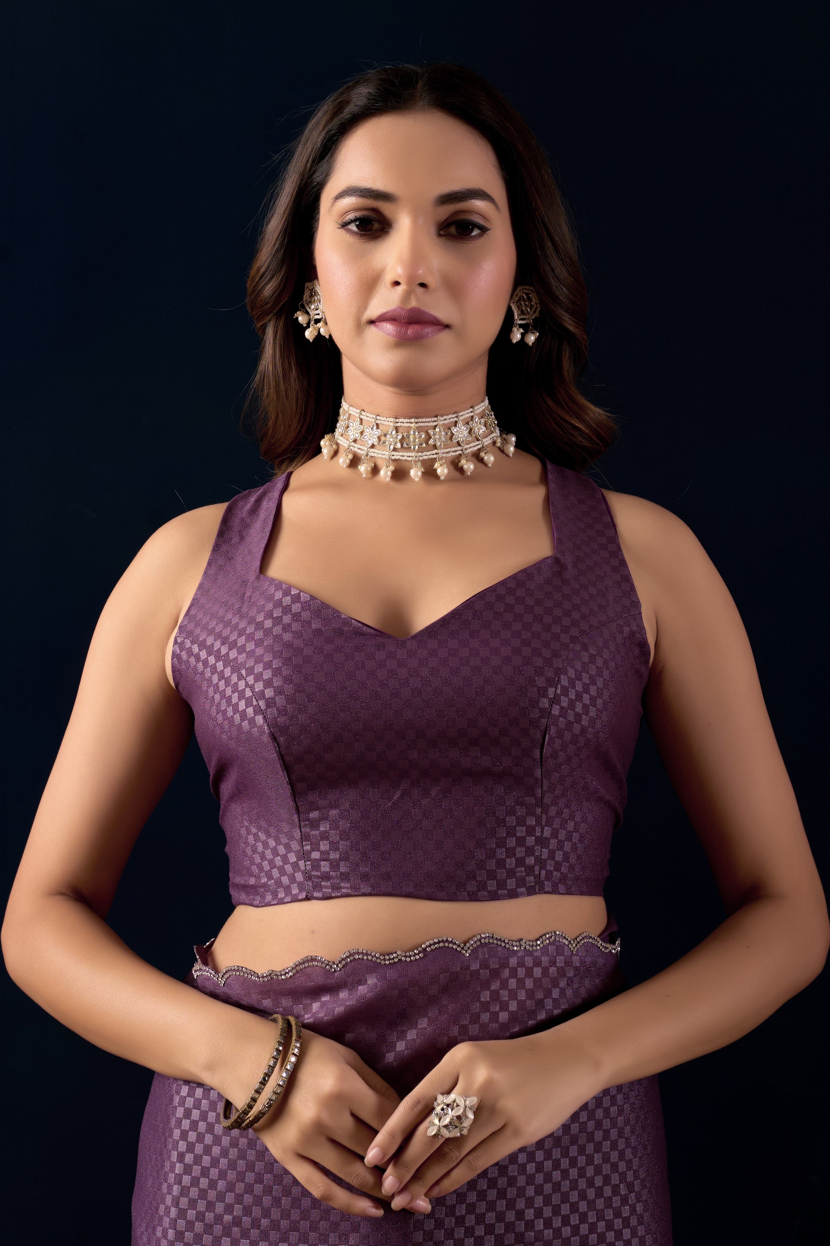 Shimmering metallic checkered Poly Georgette saree with an elegant scalloped border.