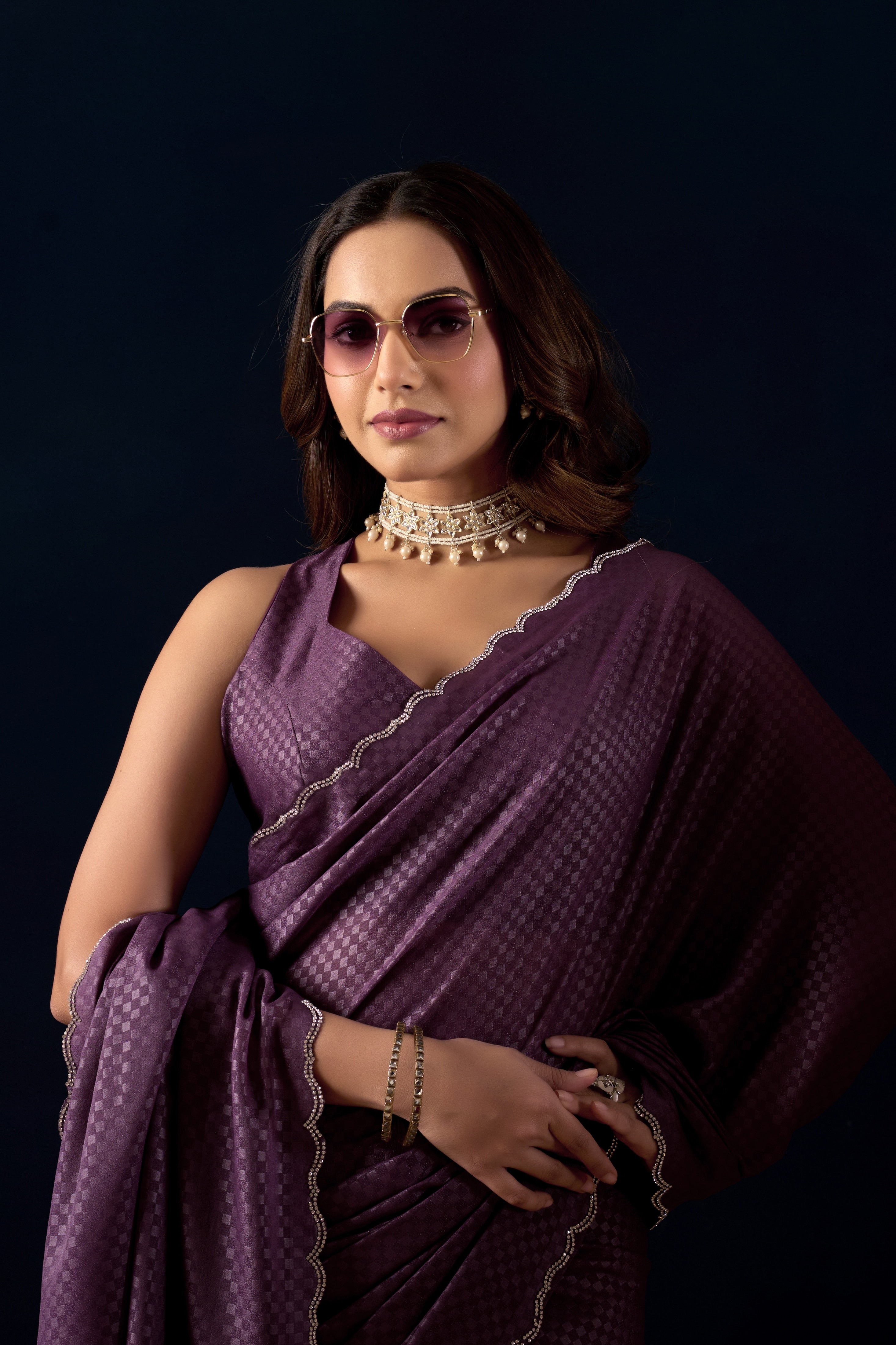 Shimmering metallic checkered Poly Georgette saree with an elegant scalloped border.