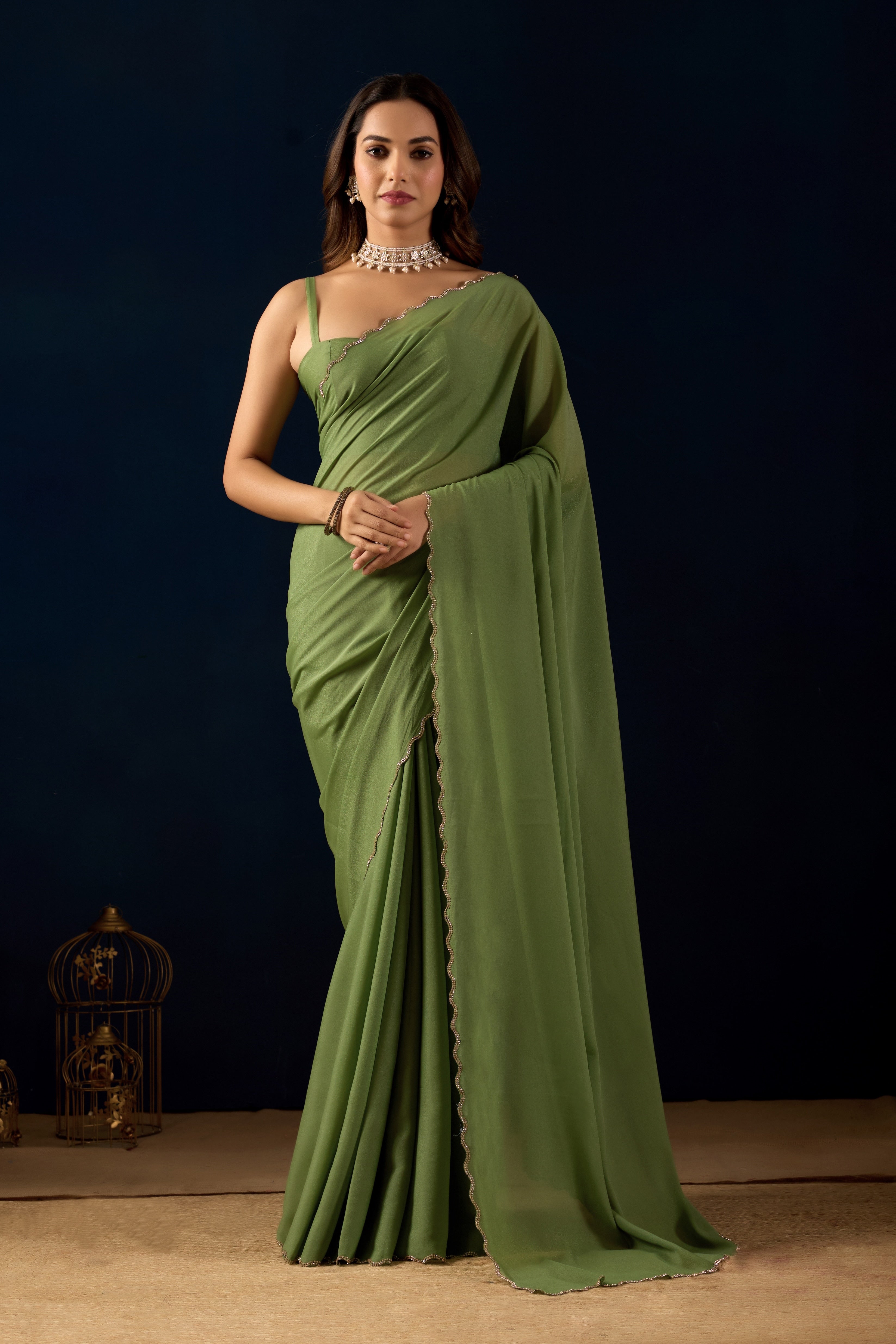 A stunning Ready-to-Wear Poly Georgette saree with a shimmering metallic finish and an elegant scalloped border for a sophisticated, hassle-free look.